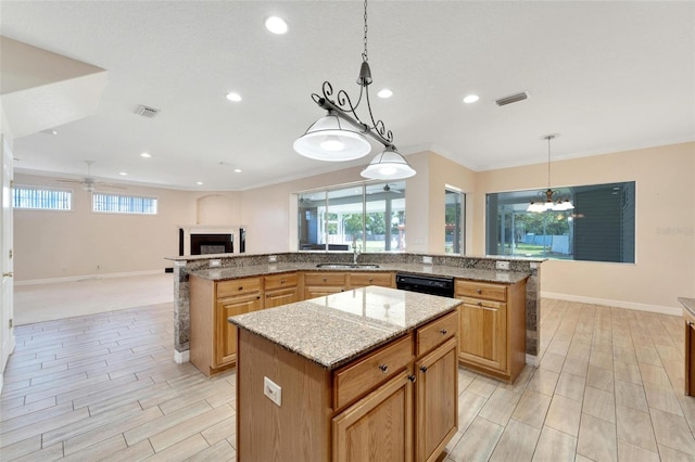 kitchen with a kitchen island, hanging light fixtures, ceiling fan with notable chandelier, and black dishwasher