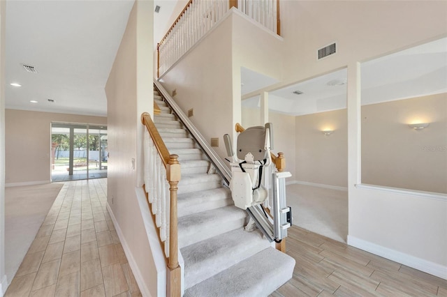 11305 Sweet Bay Ct, Riverview, FL 33569 - stairs featuring wood tiled floors, baseboards, recessed lighting, and a towering ceiling