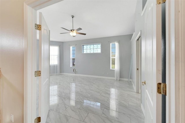 11305 Sweet Bay Ct, Riverview, FL 33569 - empty room featuring light marble finish flooring, a ceiling fan, and baseboards