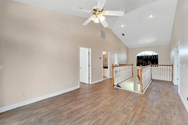 unfurnished living room featuring ceiling fan, wood-type flooring, and vaulted ceiling