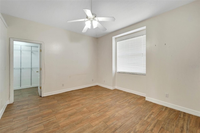 11305 Sweet Bay Ct, Riverview, FL 33569 - empty room with light wood-style floors, baseboards, and a ceiling fan