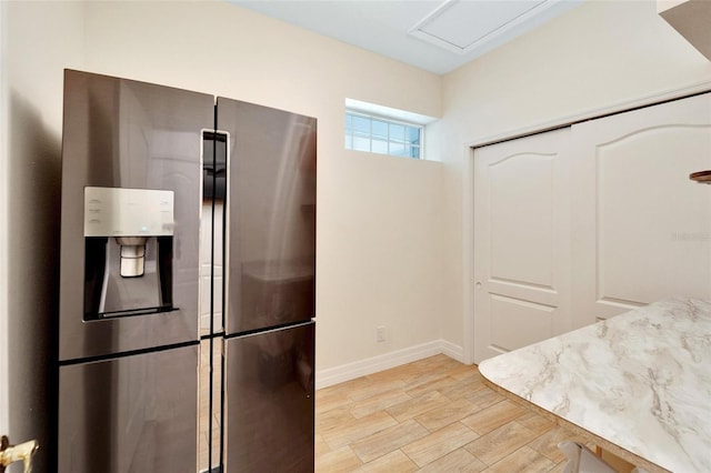 11305 Sweet Bay Ct, Riverview, FL 33569 - kitchen featuring stainless steel fridge, baseboards, and light wood-style floors