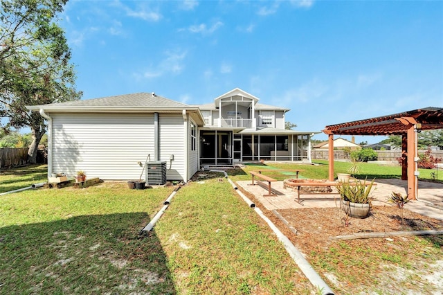 rear view of house with a sunroom, a patio area, a pergola, and a yard