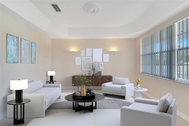 living room featuring a tray ceiling