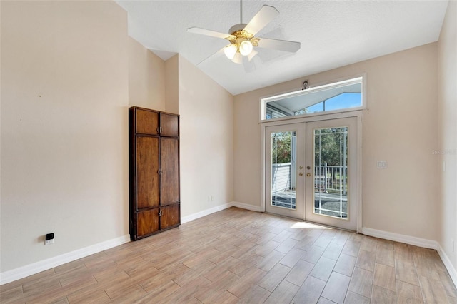 unfurnished room featuring ceiling fan, lofted ceiling, and french doors