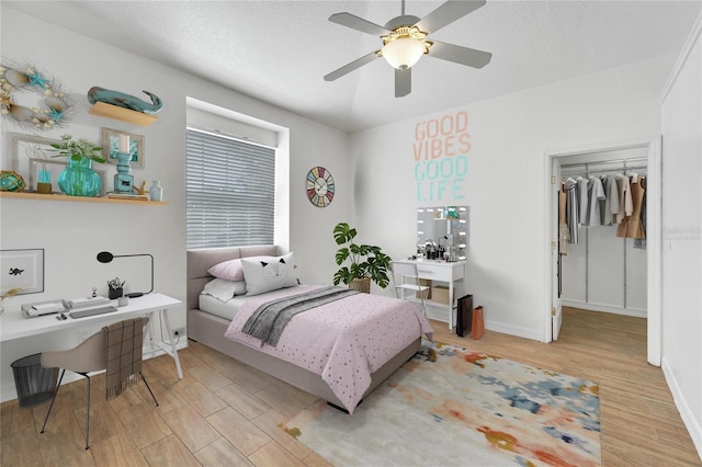 bedroom with ceiling fan, a closet, and light wood-type flooring