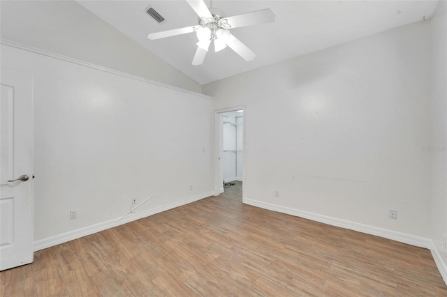 empty room featuring ceiling fan, lofted ceiling, and light wood-type flooring