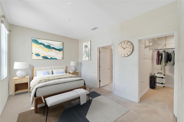 carpeted bedroom featuring a spacious closet, multiple windows, and a closet