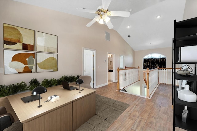 office area with light wood-type flooring, ceiling fan, and lofted ceiling