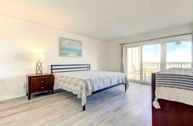 bedroom featuring access to outside and light hardwood / wood-style flooring