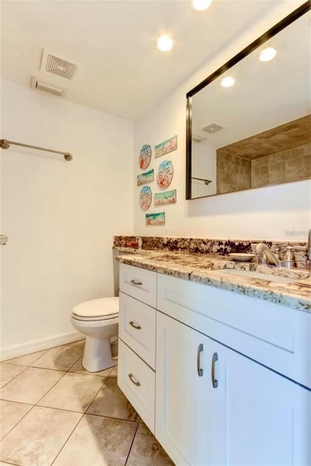 bathroom with tile patterned floors, vanity, and toilet