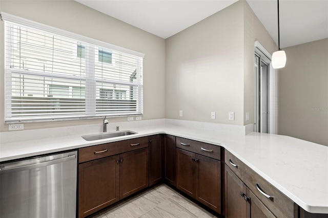 kitchen featuring pendant lighting, dishwasher, sink, dark brown cabinets, and kitchen peninsula