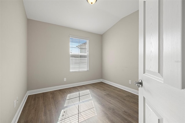 empty room featuring hardwood / wood-style floors and lofted ceiling