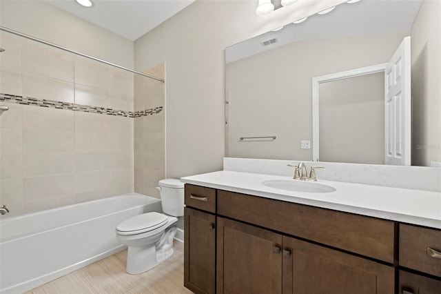 full bathroom with vanity, toilet, and tiled shower / bath