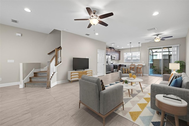 living room featuring ceiling fan and light tile patterned floors