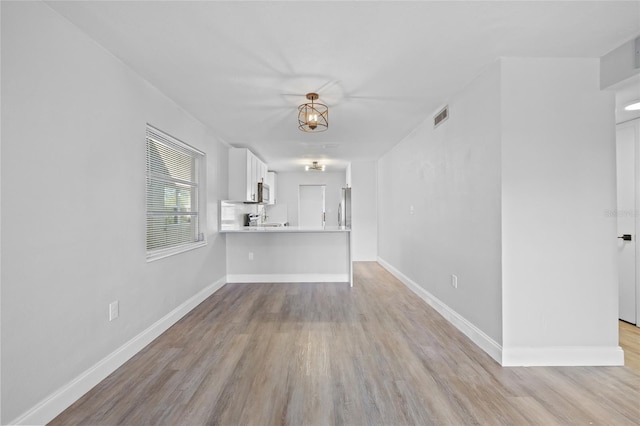 unfurnished living room with light hardwood / wood-style floors