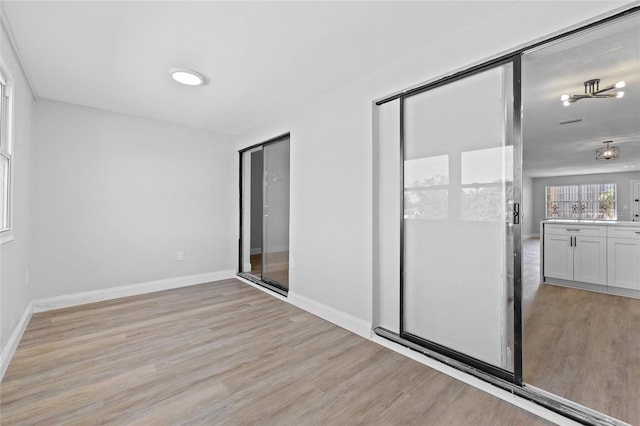 unfurnished bedroom with a closet and light hardwood / wood-style flooring