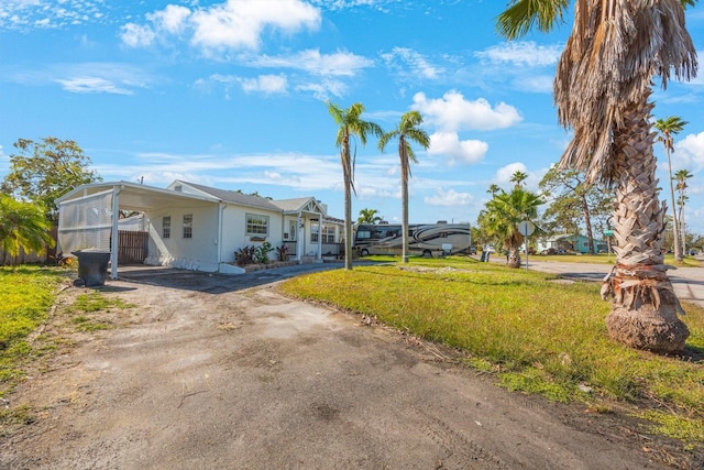 exterior space featuring a front lawn and a carport