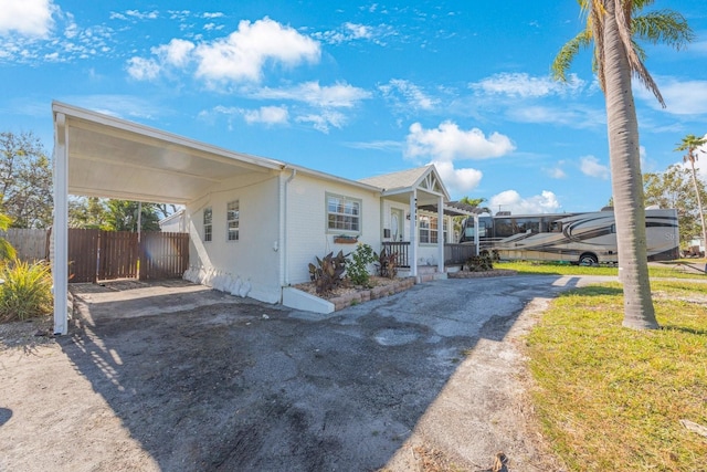 view of front of house featuring a porch and a carport