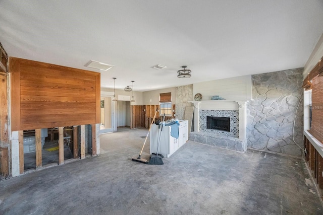 unfurnished living room with a tile fireplace