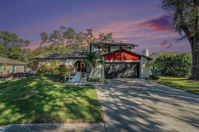 view of front of home featuring a yard and a garage