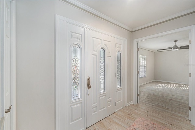 foyer featuring ceiling fan, light wood-type flooring, and ornamental molding