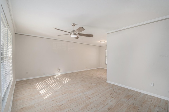 empty room with ceiling fan, light hardwood / wood-style flooring, and ornamental molding