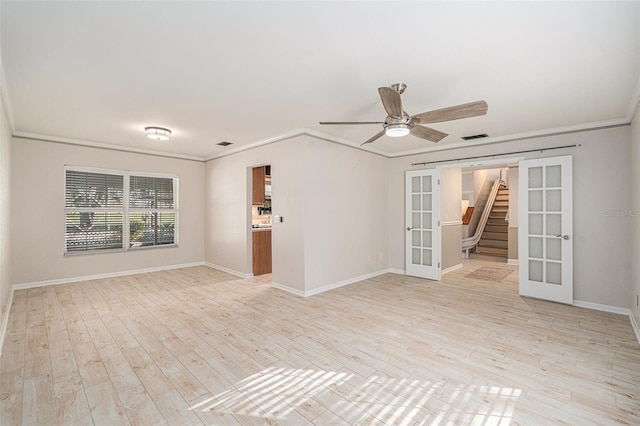 spare room with ceiling fan, ornamental molding, light hardwood / wood-style flooring, and french doors