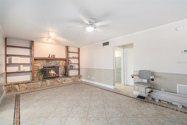 unfurnished living room featuring ceiling fan, a fireplace, light tile patterned floors, and ornamental molding