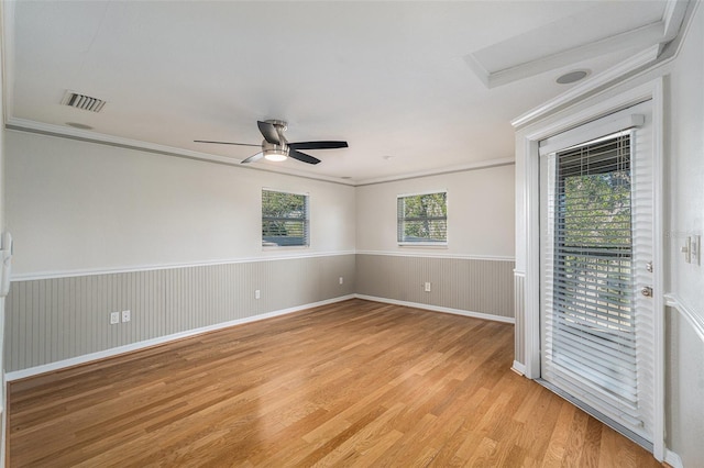 empty room featuring ceiling fan, light hardwood / wood-style floors, and ornamental molding