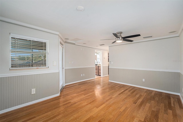 unfurnished room with ceiling fan, light hardwood / wood-style flooring, and ornamental molding