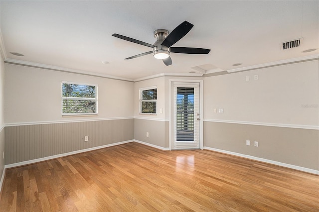 unfurnished room featuring light wood-type flooring, ceiling fan, and crown molding