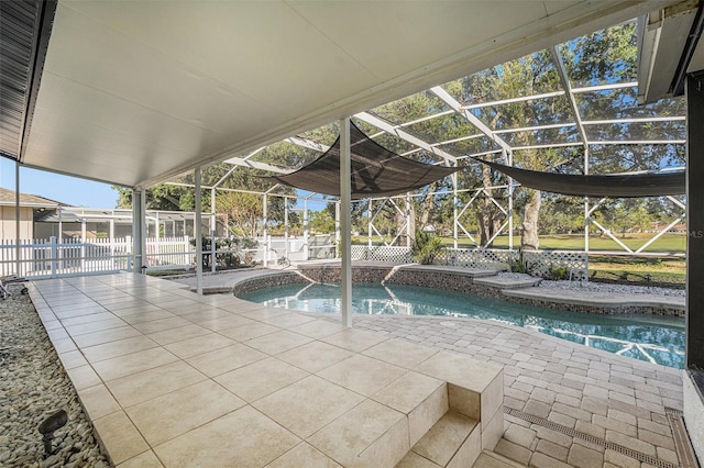 view of swimming pool featuring a patio and a lanai