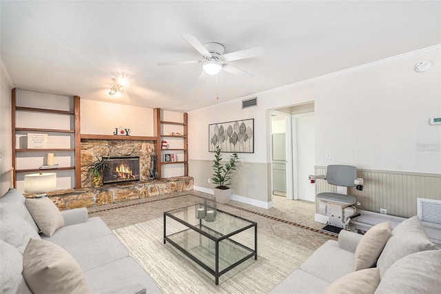 living room with ceiling fan, light tile patterned floors, a fireplace, and ornamental molding