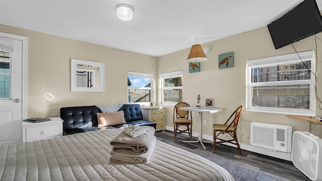 483 E Shore Dr Unit D3, Clearwater Beach, FL 33767 - bedroom with wood finished floors, baseboards, and an AC wall unit