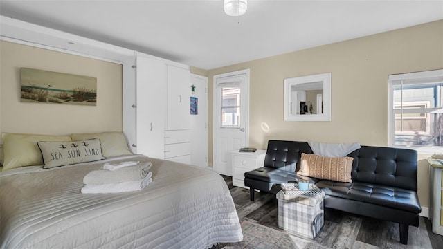 bedroom featuring hardwood / wood-style floors and multiple windows