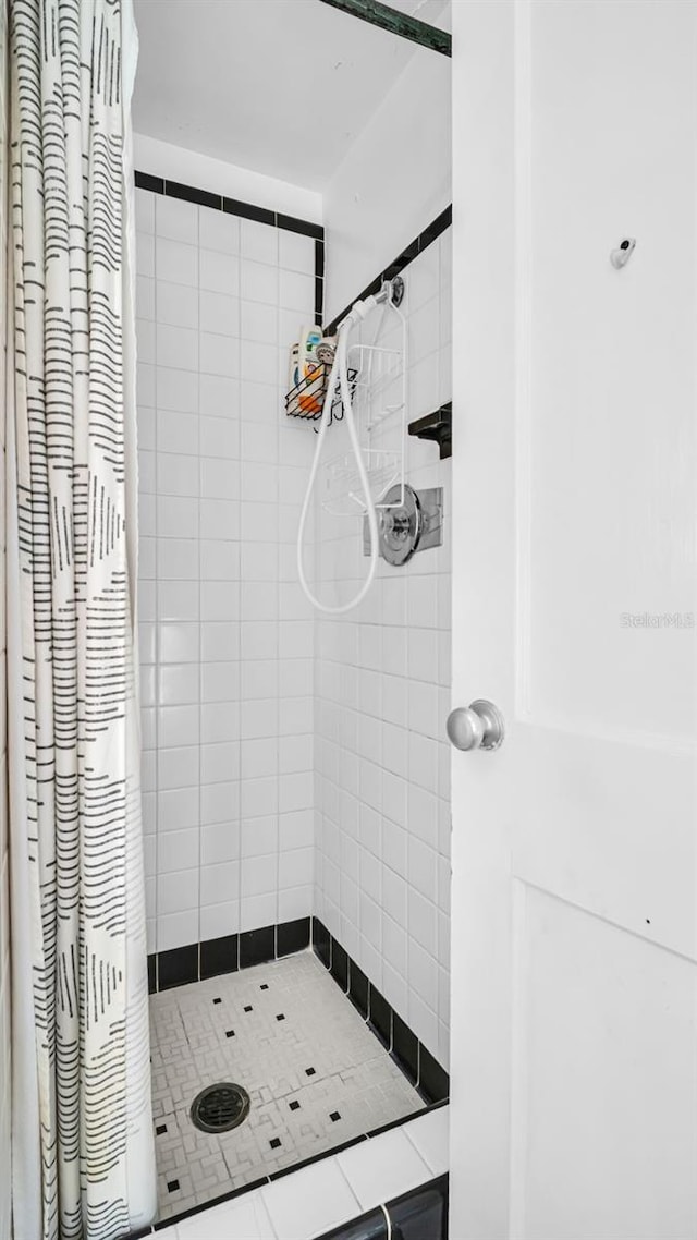 bathroom with tile patterned flooring and a shower with curtain