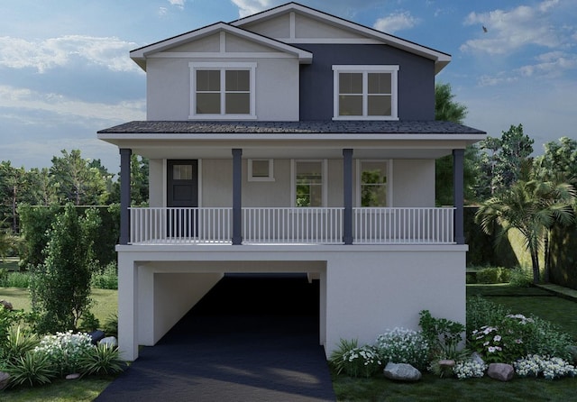 840 61st Ave NE, Saint Petersburg, FL 33703 - raised beach house featuring decorative driveway, stucco siding, a porch, and an attached garage