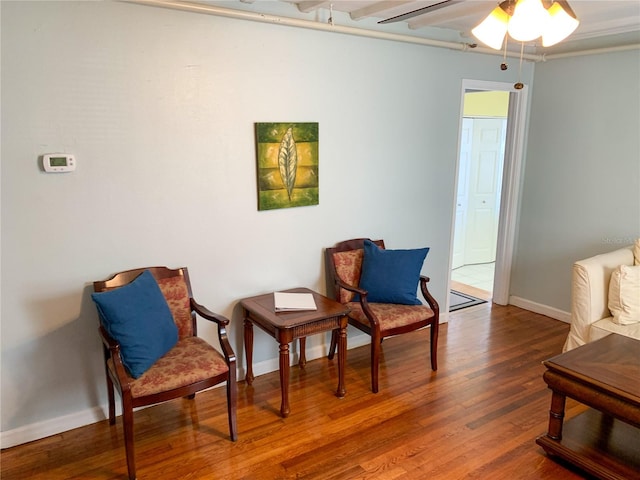 living area featuring hardwood / wood-style flooring and ceiling fan