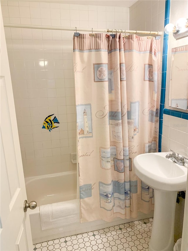 bathroom with tile patterned floors and shower / bath combo with shower curtain