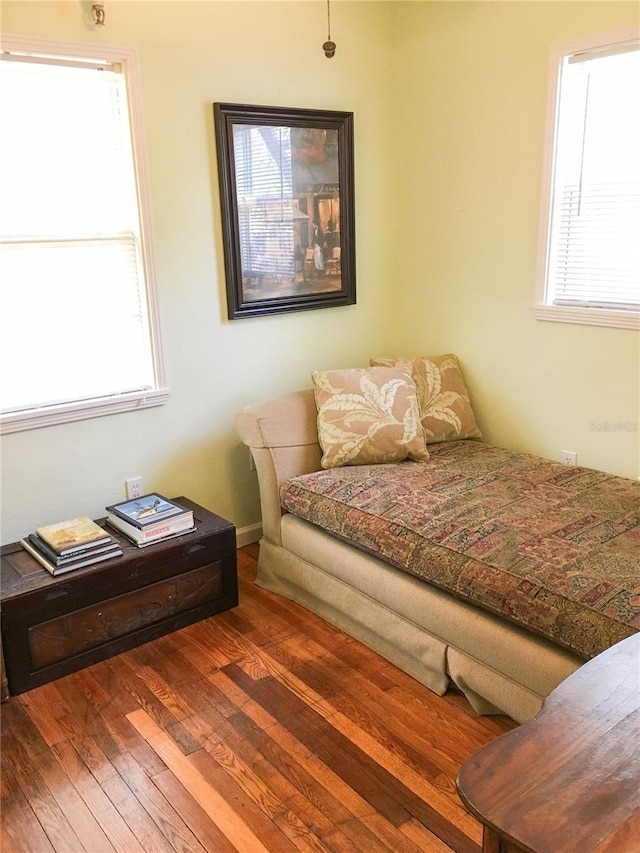 bedroom with dark hardwood / wood-style flooring