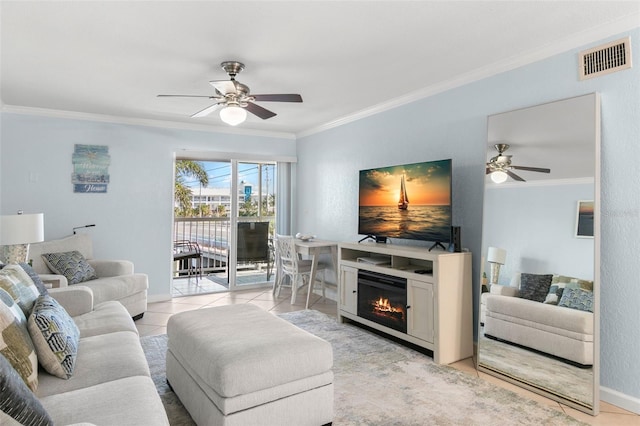 living room with ceiling fan, ornamental molding, and light tile patterned flooring