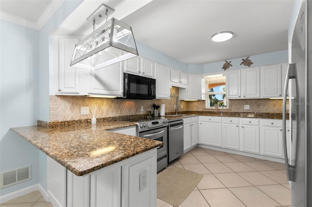 kitchen with white cabinets, kitchen peninsula, light tile patterned flooring, and stainless steel appliances