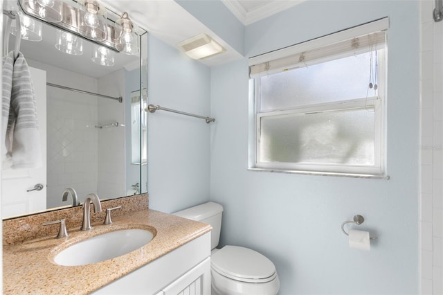 bathroom featuring toilet, vanity, and crown molding