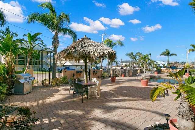 view of patio / terrace with a swimming pool and a grill