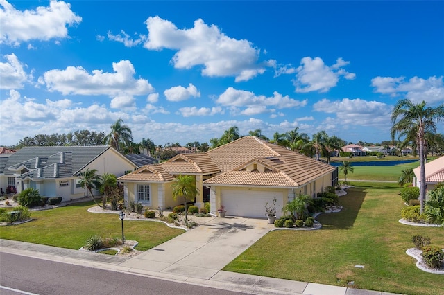 mediterranean / spanish-style home featuring a garage and a front lawn