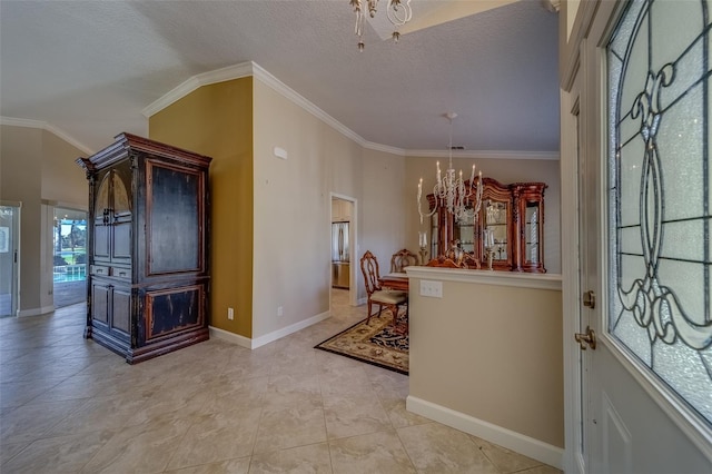 entryway with a textured ceiling, crown molding, and a chandelier