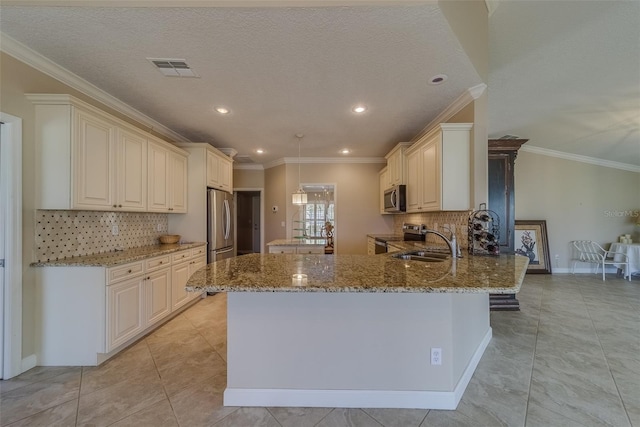 kitchen featuring sink, light stone counters, kitchen peninsula, decorative backsplash, and appliances with stainless steel finishes