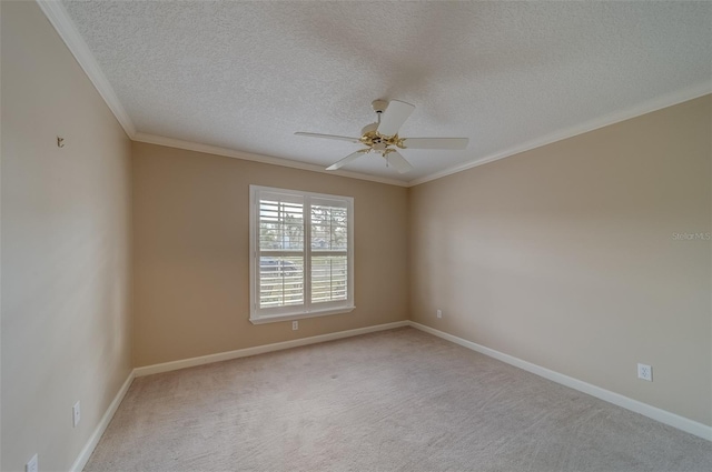 unfurnished room with ceiling fan, light colored carpet, ornamental molding, and a textured ceiling