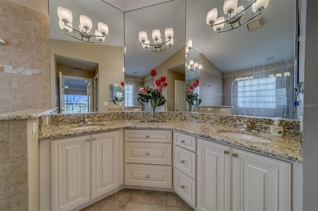 bathroom featuring tile patterned flooring, vanity, tile walls, and vaulted ceiling